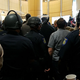 Police in riot gear stand guard in the foyer of Sacramento, Calif., City Hall on March 27, 2018.